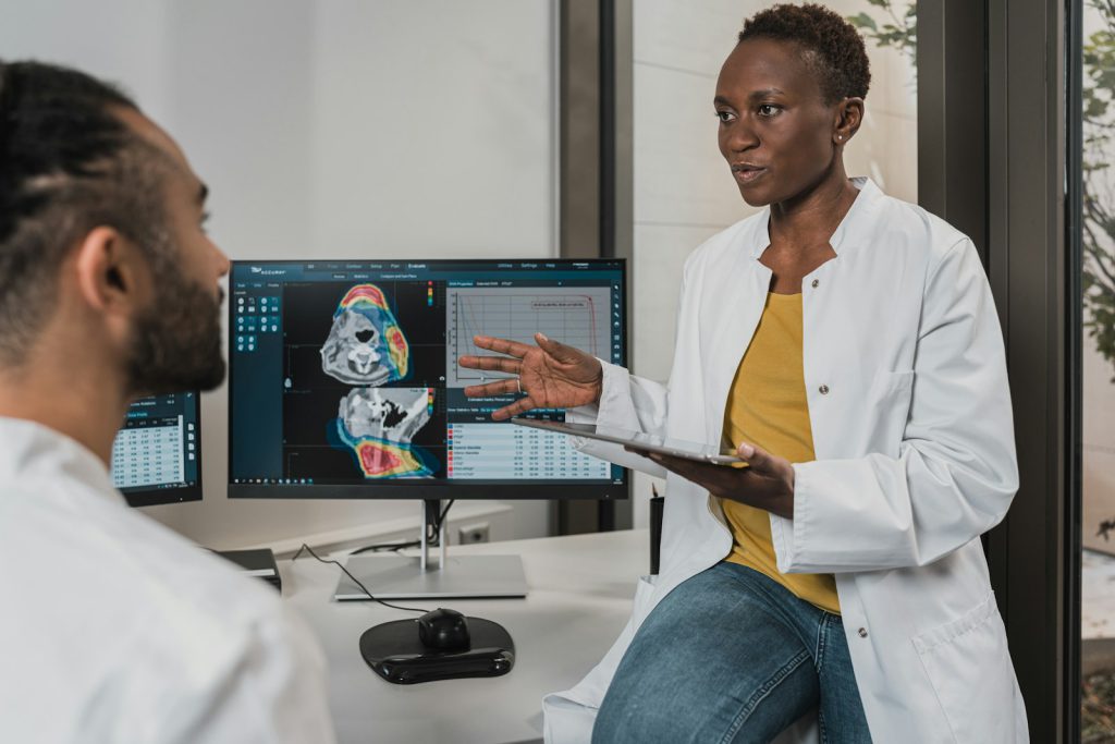A clinician discussing medical imaging with a patient