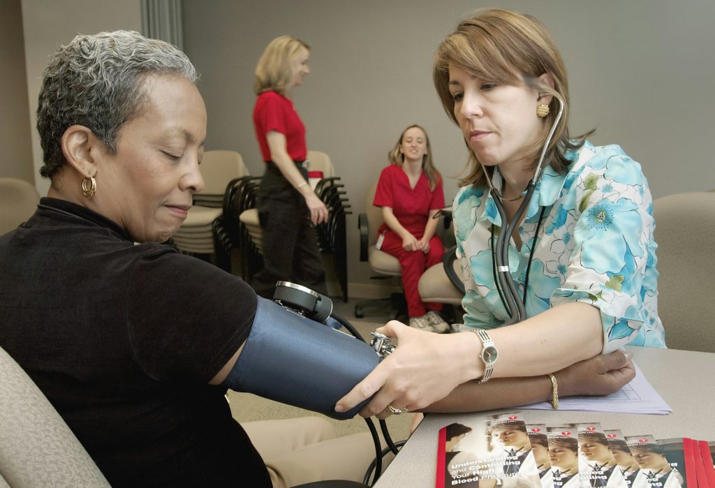 A nurse measuring a patient's blood pressure