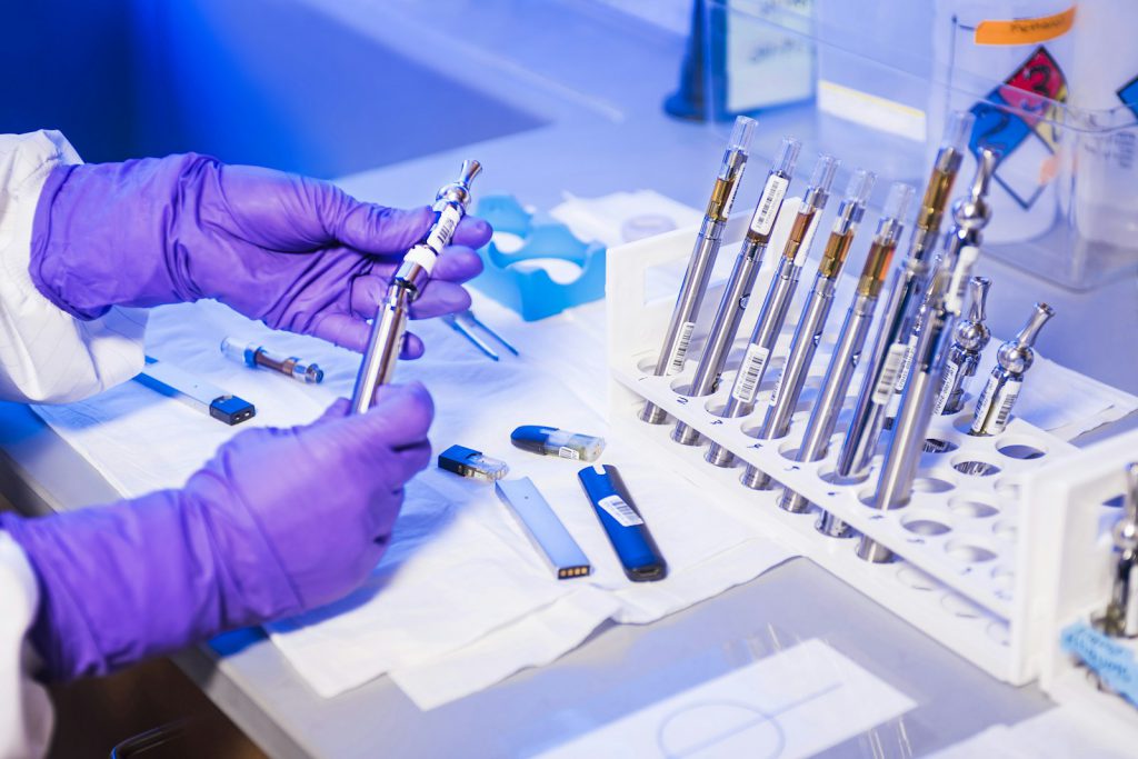 Gloved hands preparing medical instruments