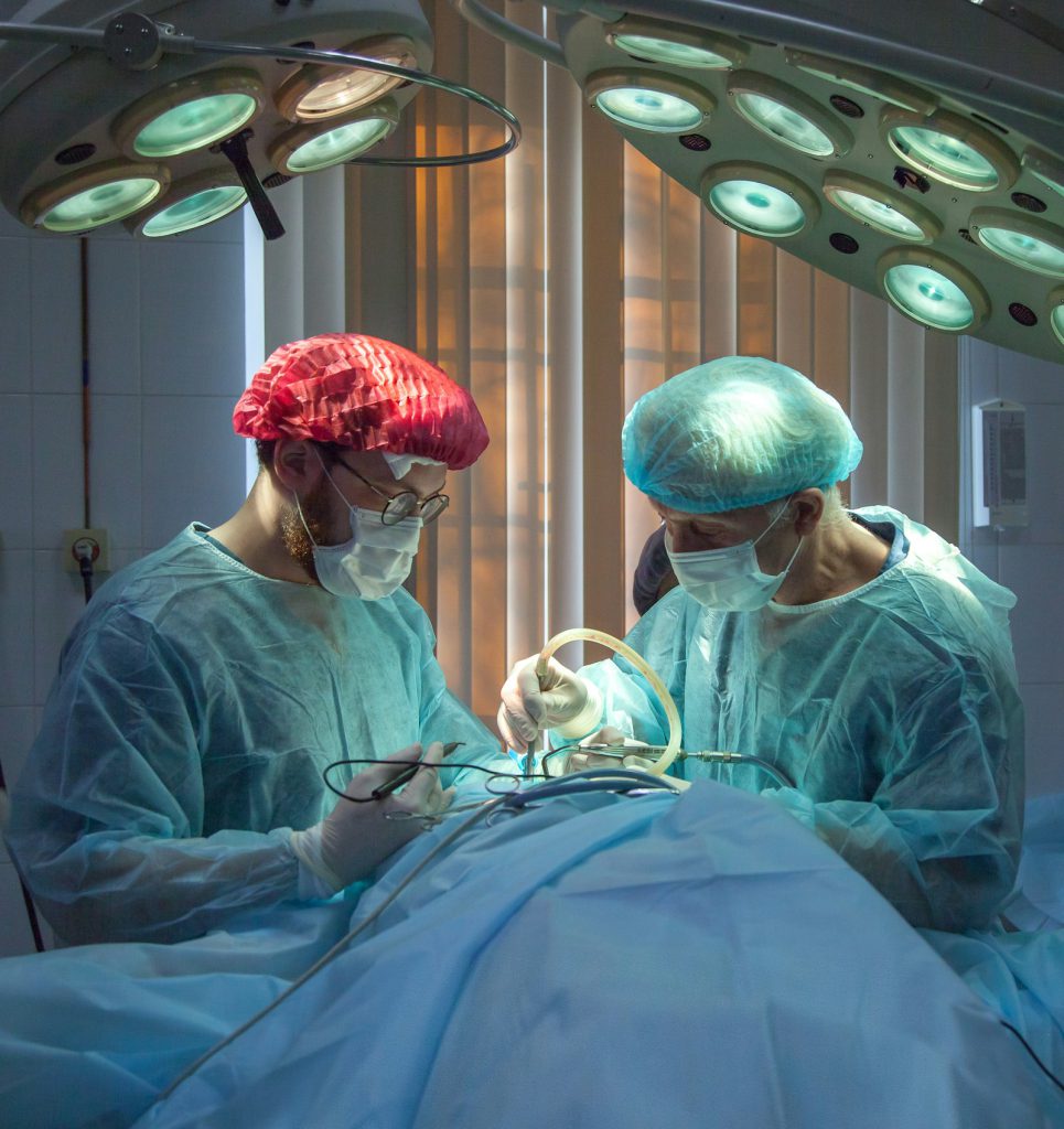 Surgeons operating under theatre lights